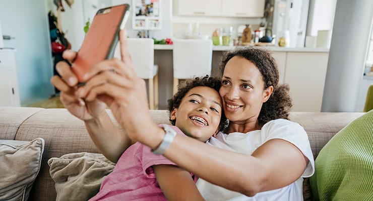 A mother and son looking at extras cover on a mobile phone.