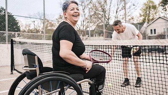 Woman in a wheelchair playing tennis