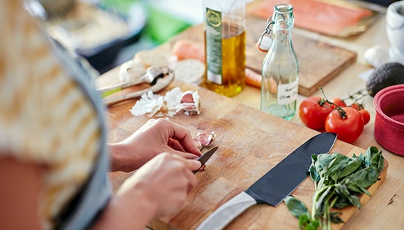 preparing vegetables on a chopping board to reduce salt intake