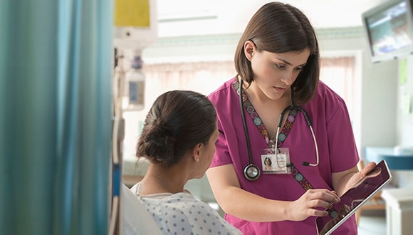 A nurse talking to a patient