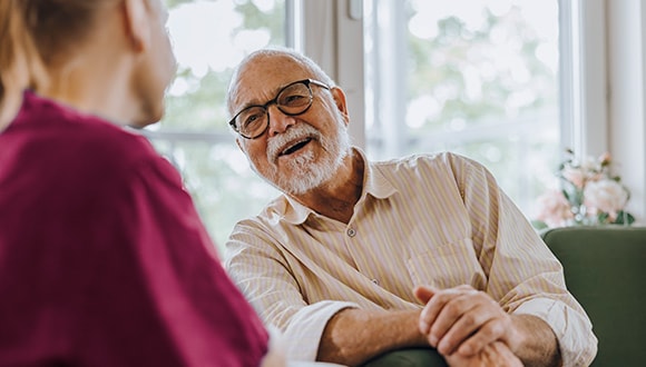 Older connecting with another person and smiling