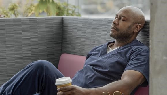 Man looking exhausted as he experiences work burnout