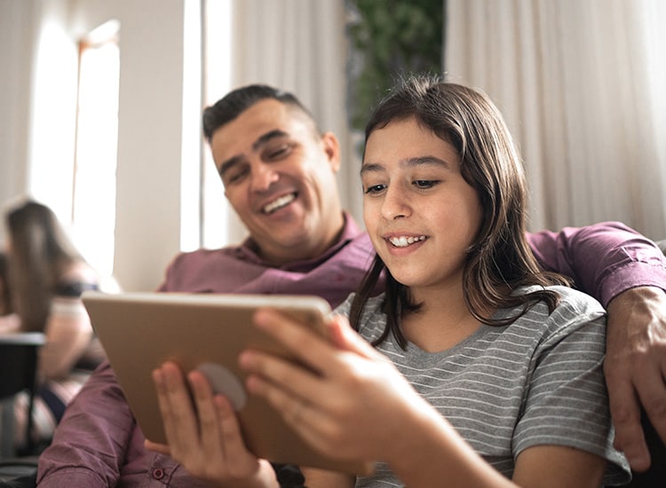 A man and woman speak to a specialist on a tablet