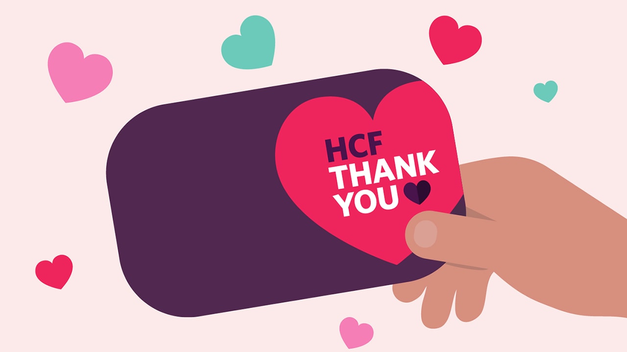 Illustration of a purple card with HCF Thank You written on it and hearts around it.