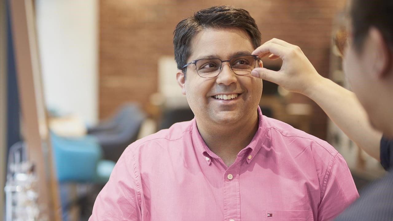 Man getting glasses fitted in HCF eyecare centre.