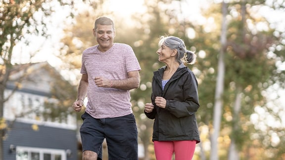 An older couple jogging in the morning.