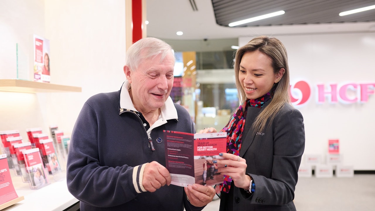 HCF customer reviewing product brochure